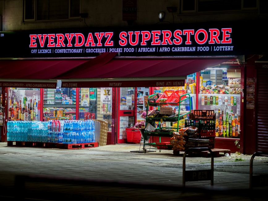 Illuminated night view of Everydayz Superstore, showcasing diverse products and cultural groceries.